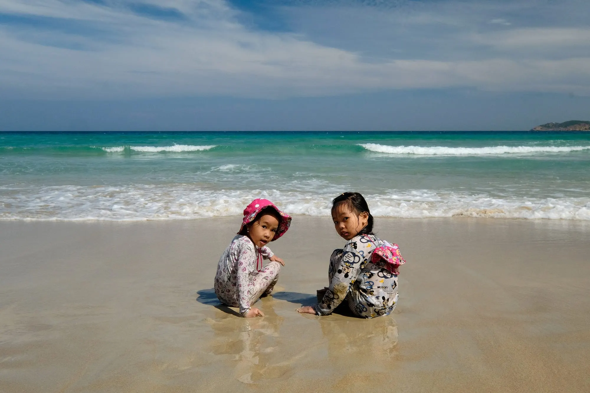 Two little girls playing on the beach near Cam Ranh, Khánh Hòa