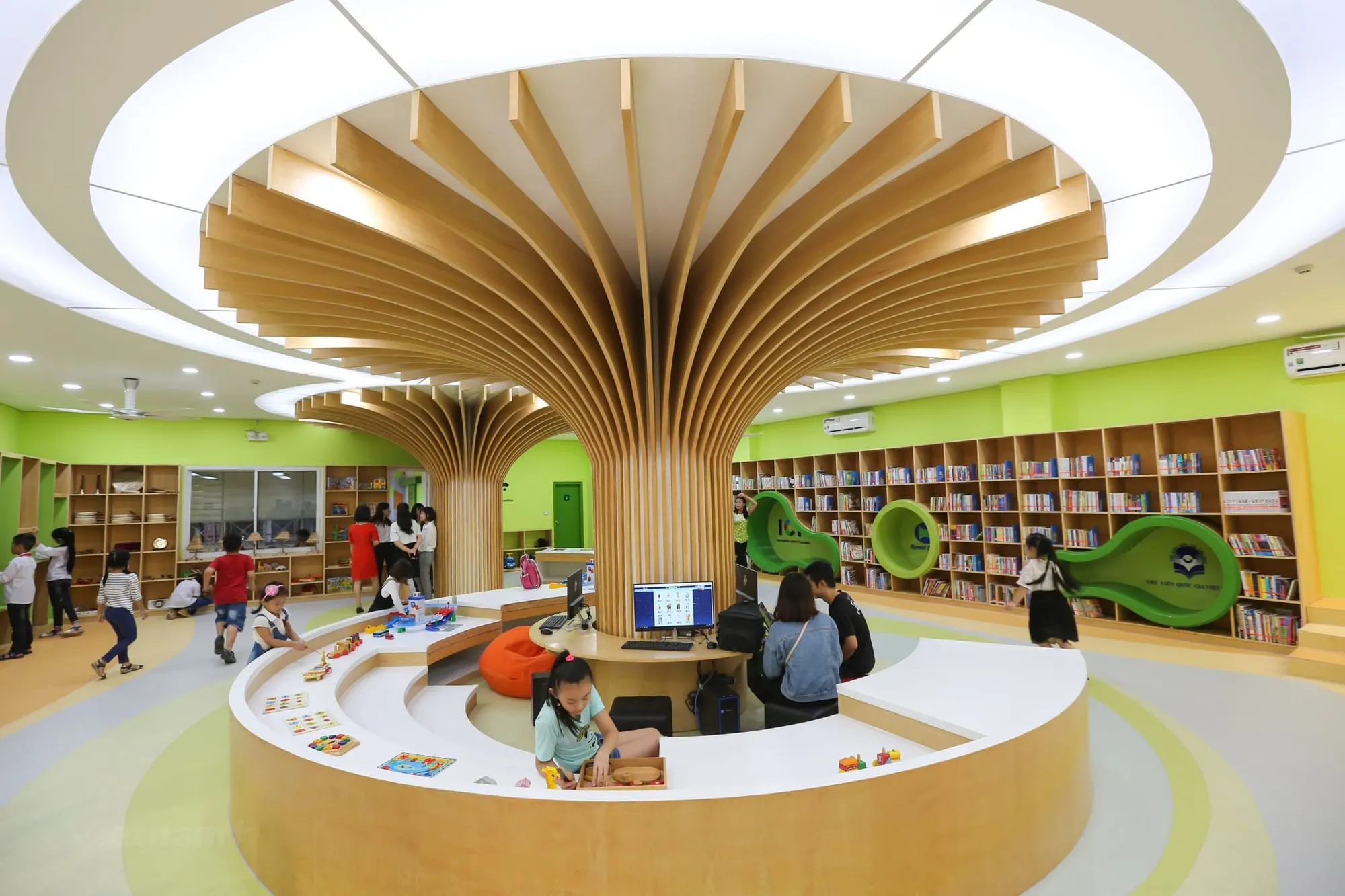 A modern children's library with bookshelves and computers